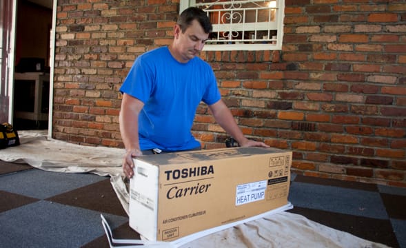 man-with-toshiba-carrier-air-conditioner