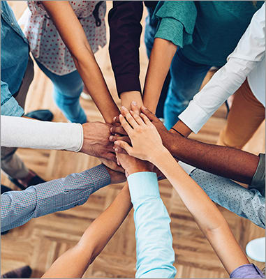 teamwork-hands-clasped-together