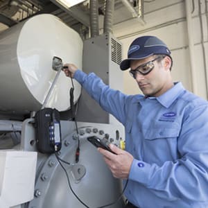 carrier-technician-evaluating-hvac-equipment-sq