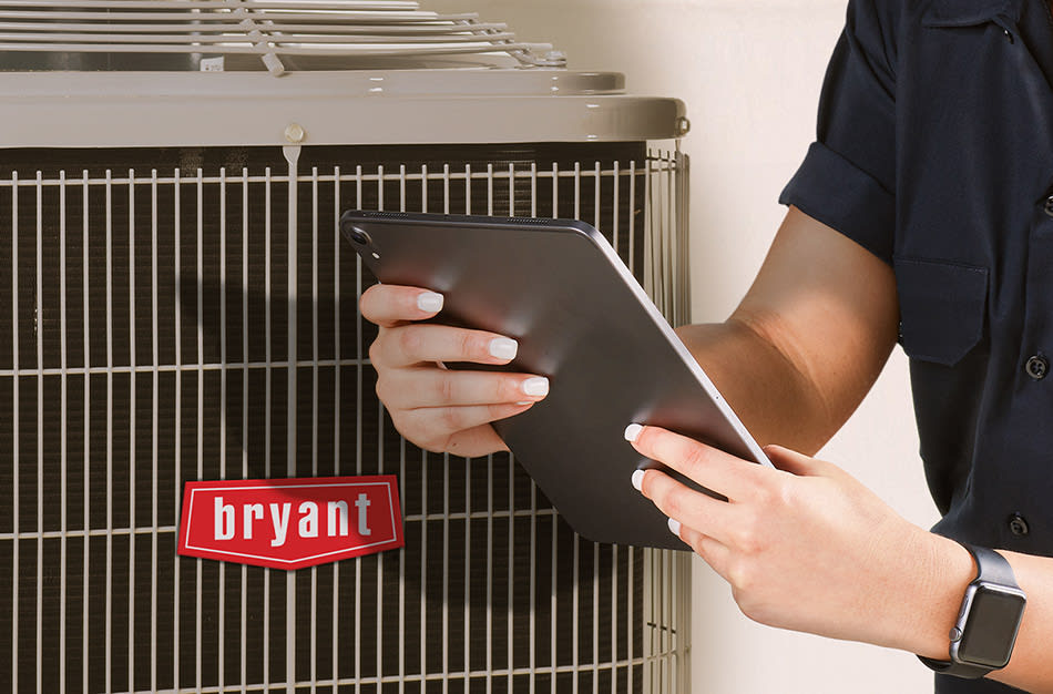 bryant-hvac-contractor-holding-ipad