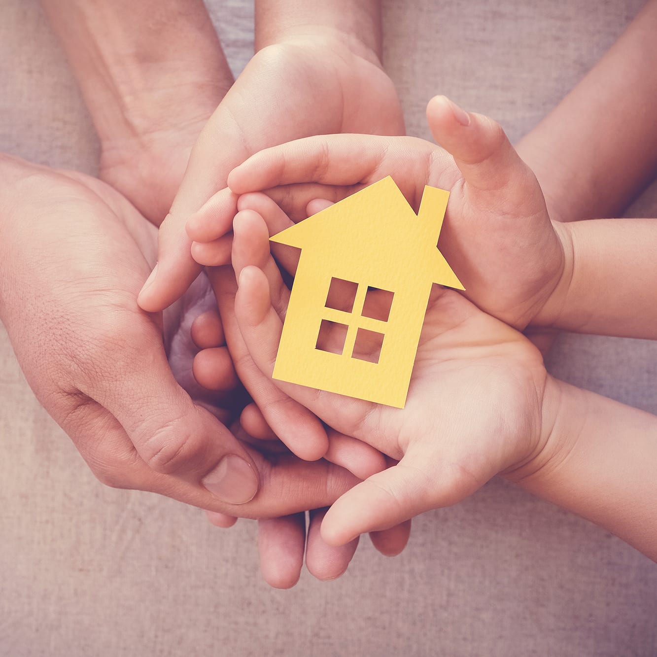 family-holding-house-in-hands-mb