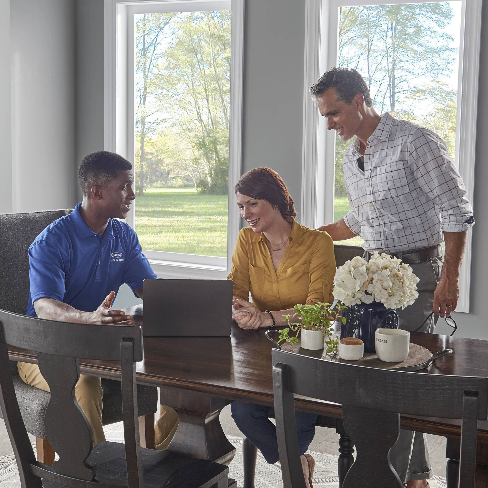 Carrier-Dealer-Reviewing-Central-Air-Conditioner-Prices-with-couple