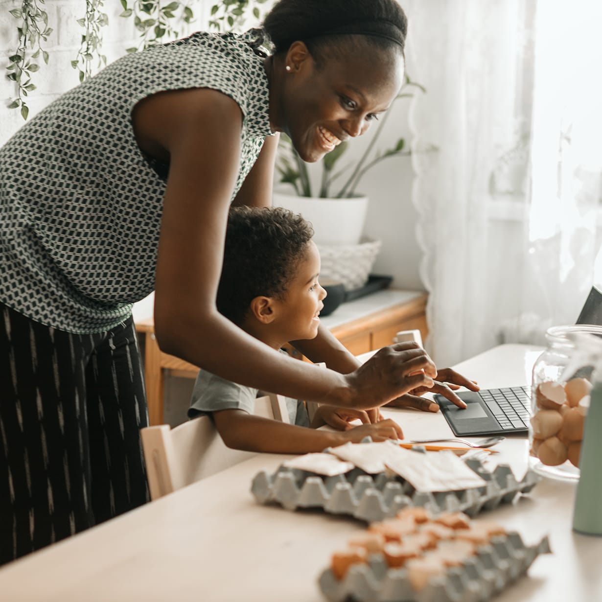mom-and-child-at-kitchen-table-with-egg-crates