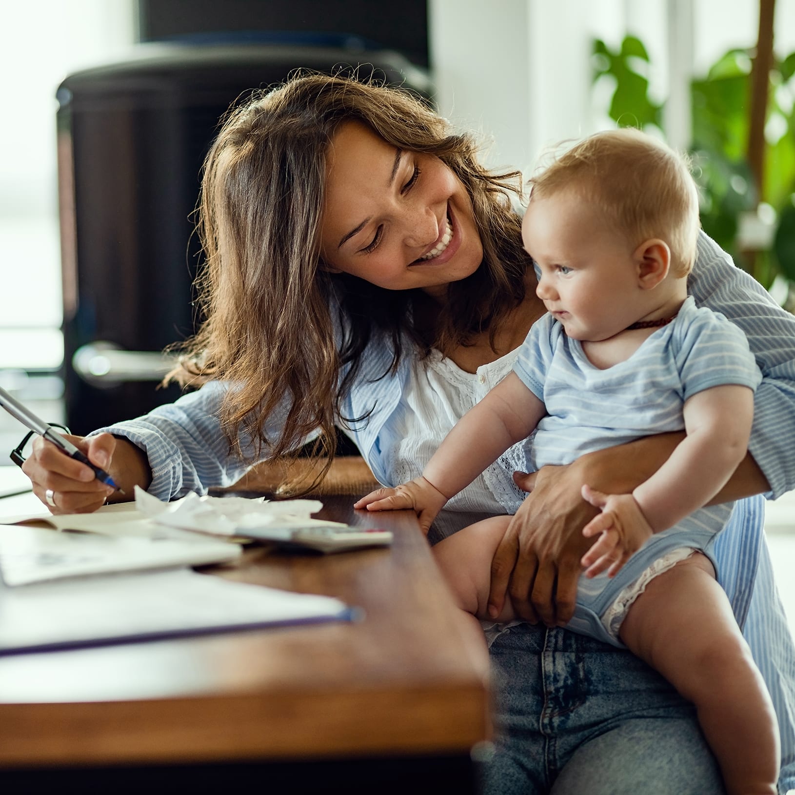 mom-and-baby-at-kitchen-table-with-paperwork