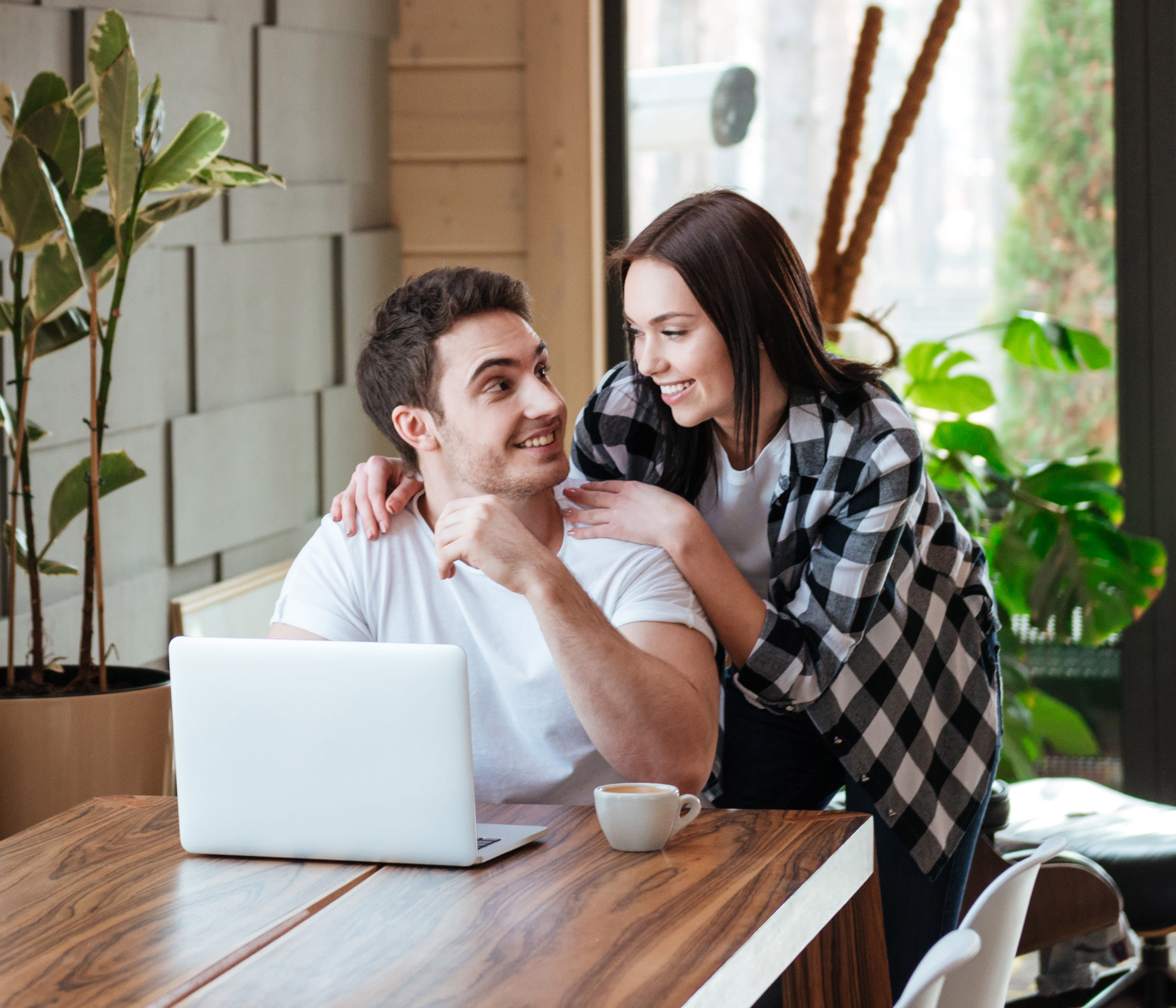 a man and a woman look at a computer while applying for Wells Fargo HVAC financing