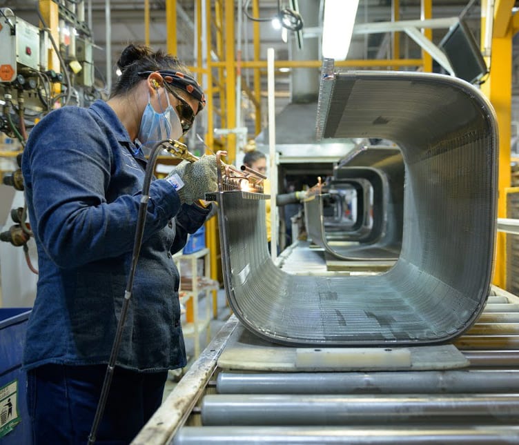 a carrier factory worker builds an air conditioner