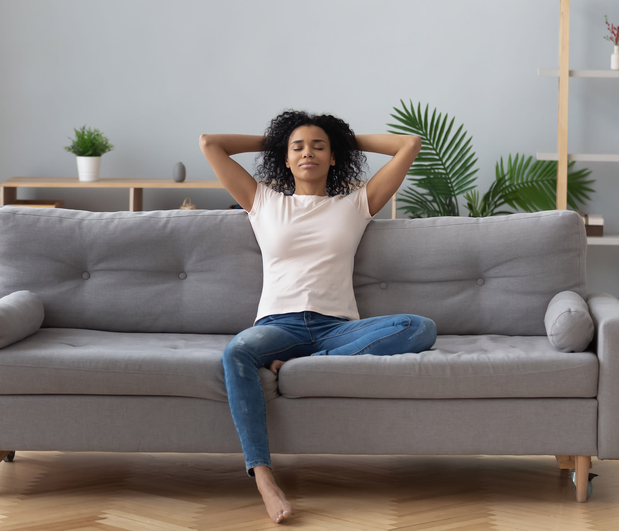 woman relaxing on couch with indoor humidity control
