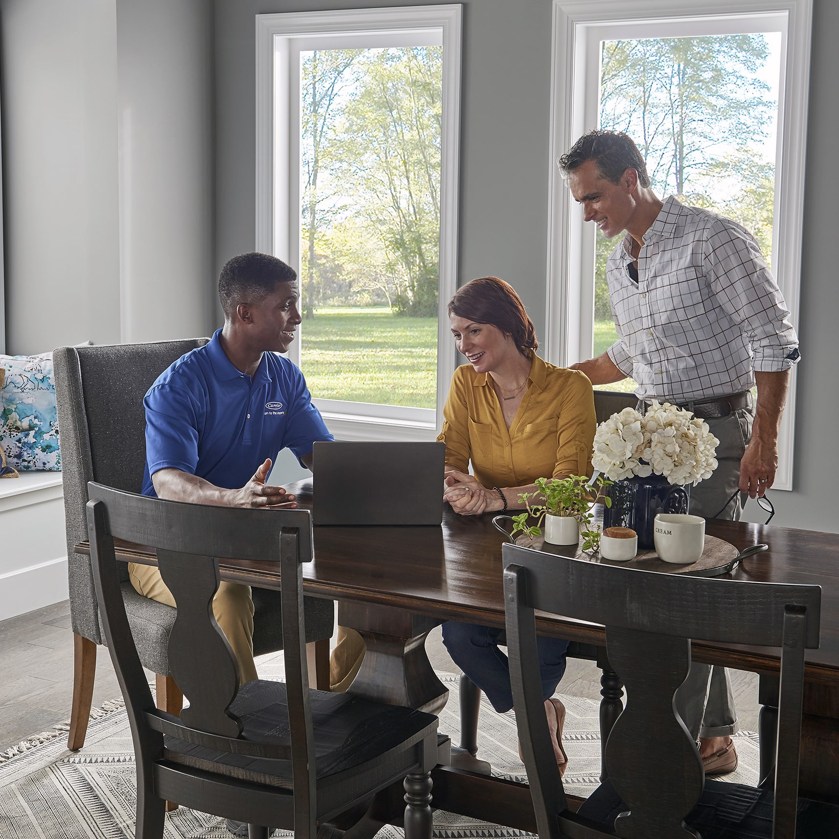 a carrier dealer talks to homeowners about finding the right HVAC solutions