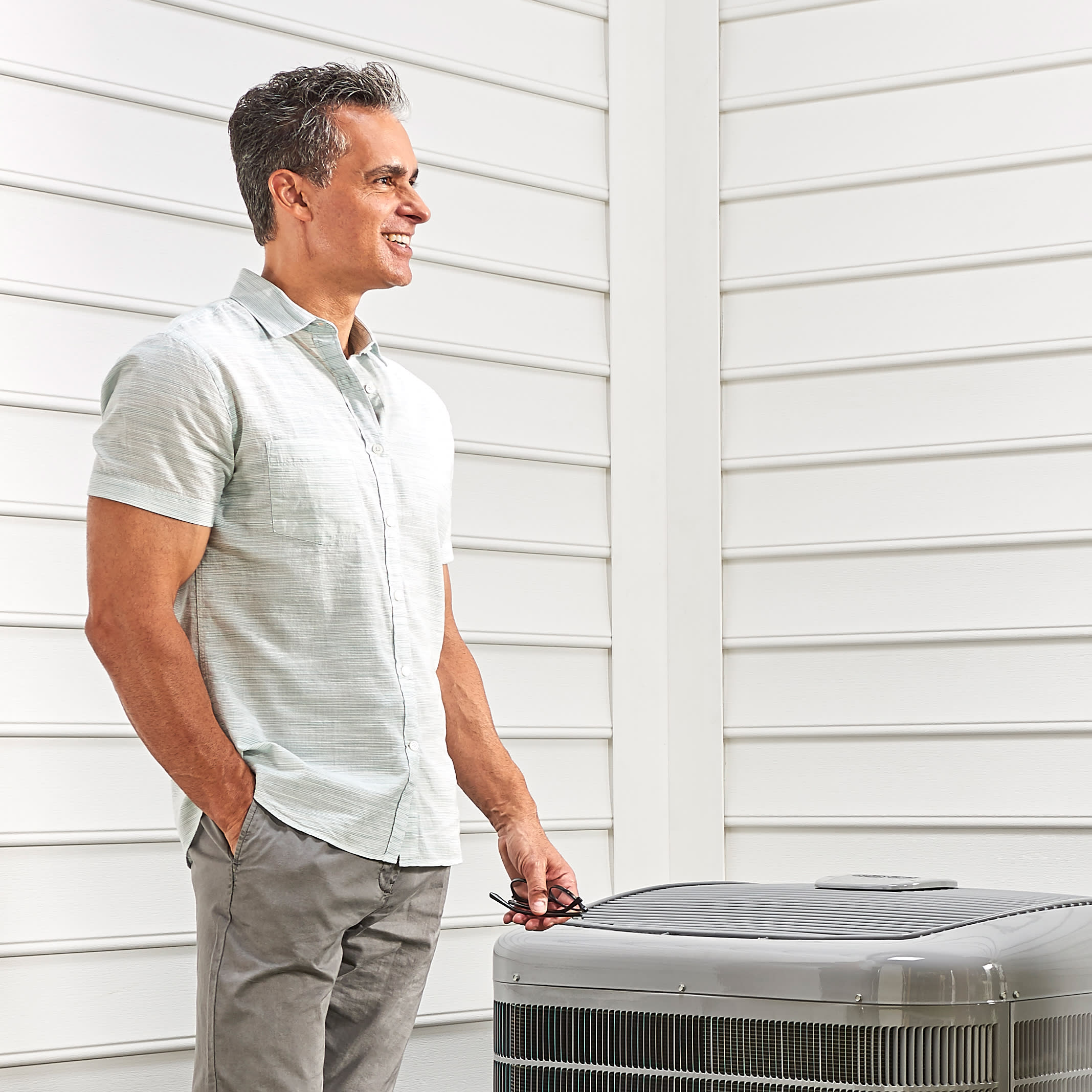 a man stands by his AC after leaving an air conditioner review