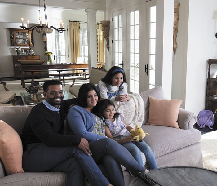 happy-family-sitting-on-couch