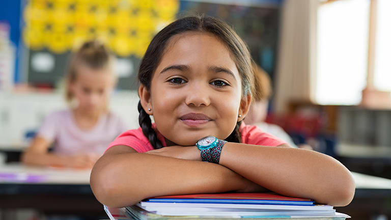 schoolgirl-in-classroom-with-books-card