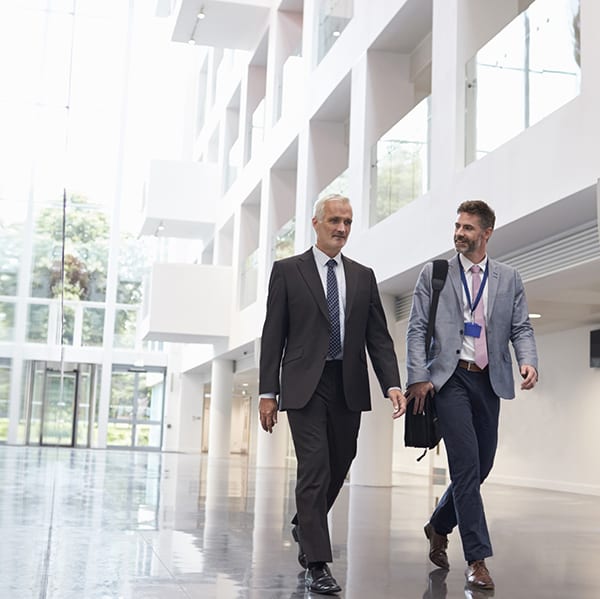carrier-two-men-walking-in-building-lobby-sq