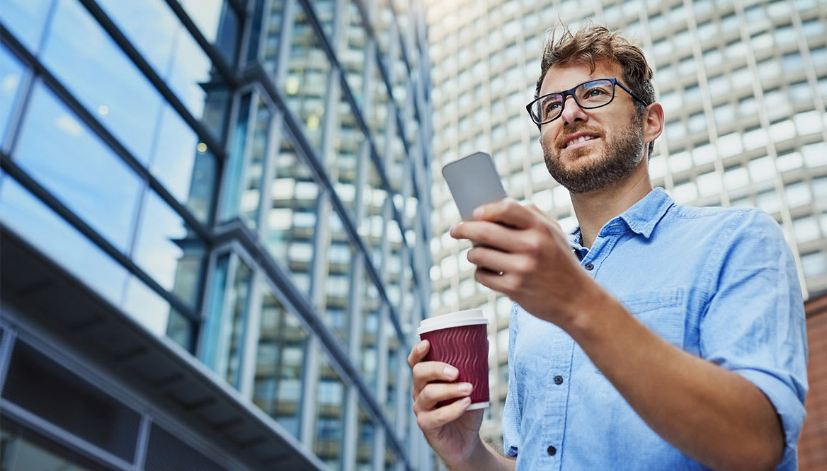 man-with-coffee-and-phone