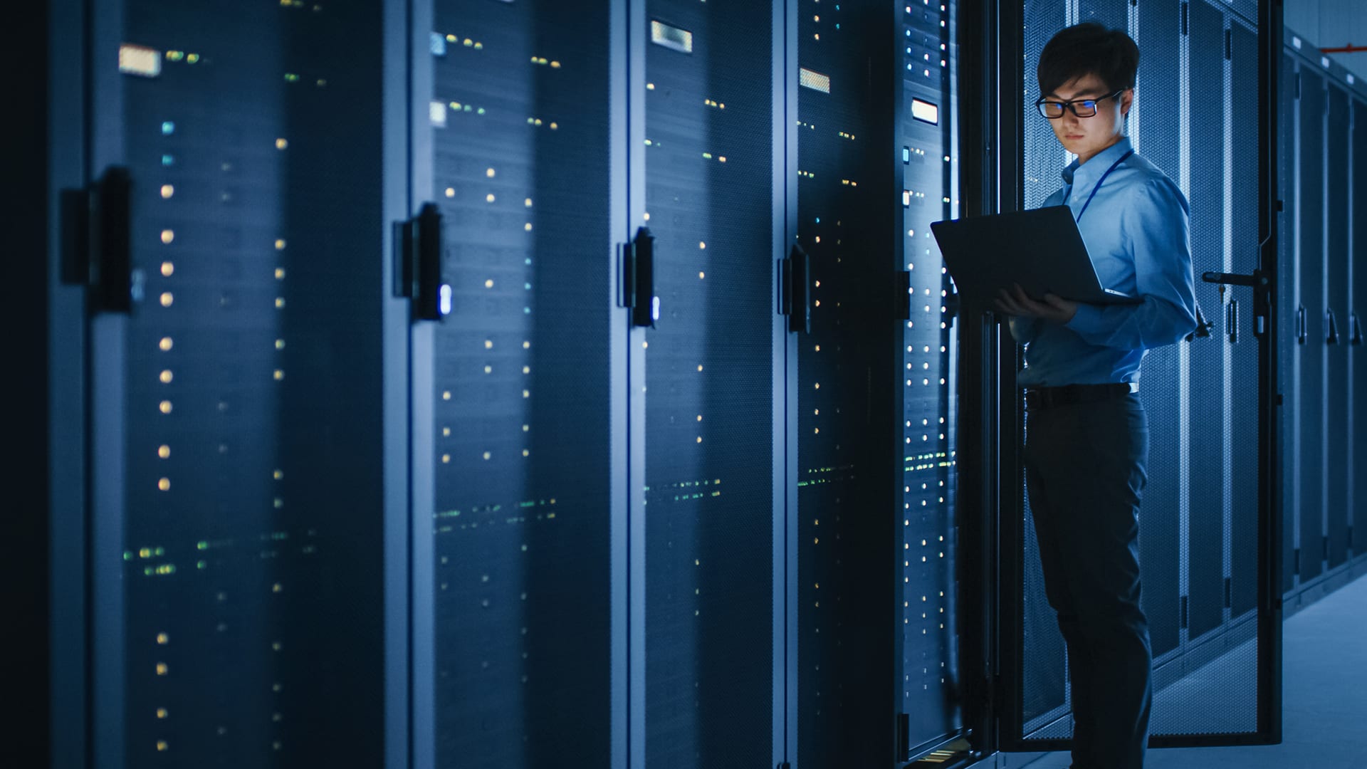 man-in-server-room-with-laptop