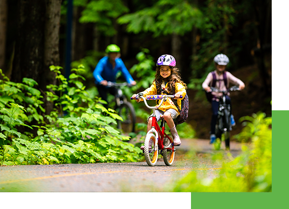a girl rides her bike through a sustainable environment