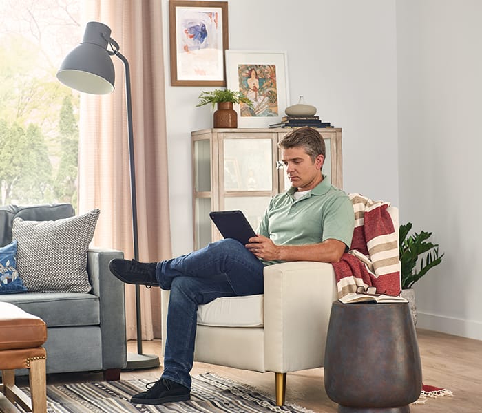 a man researches bryant intelisense technology on his tablet