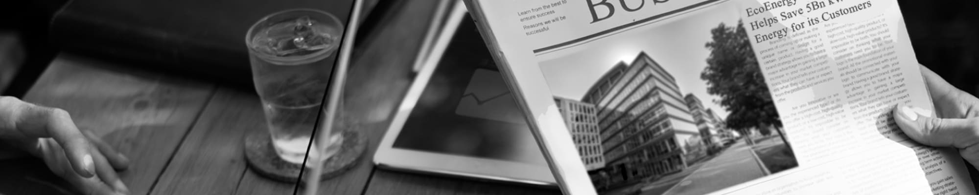 person-reading-newspaper-with-laptop-and-mobile-phone