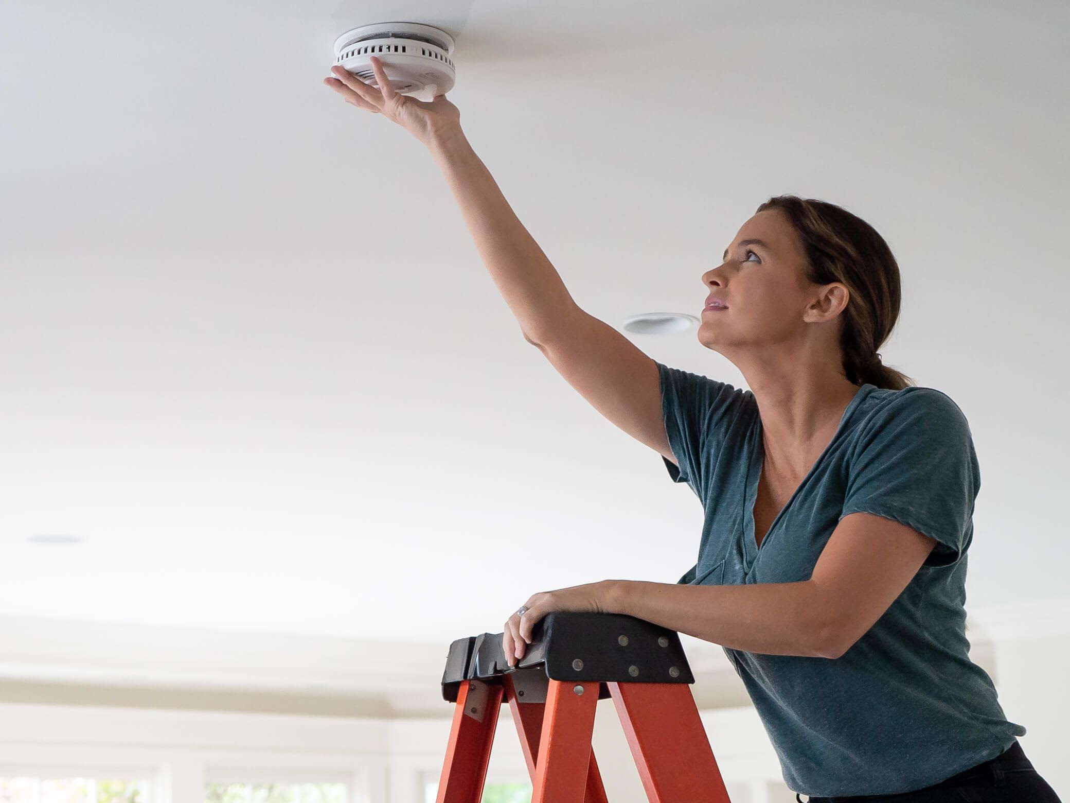 woman-installing-alarm-01-full-opt_4-3