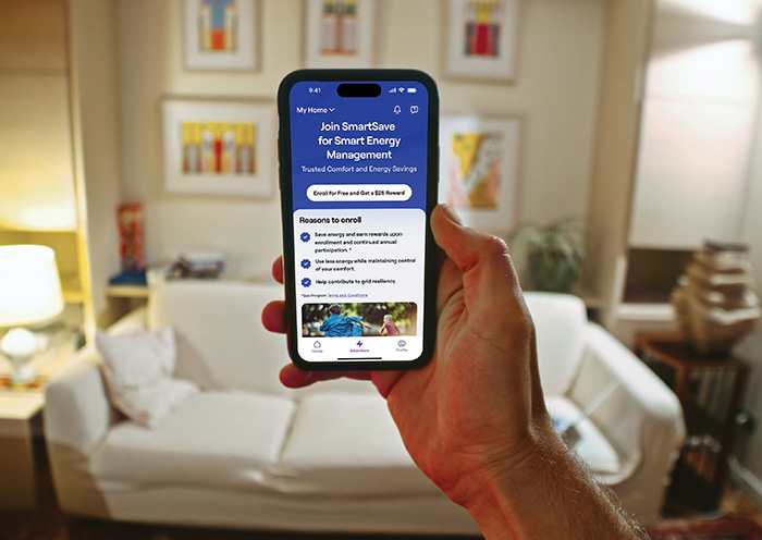 person-holding-a-phone-showing-the-carrier-smartsave-app