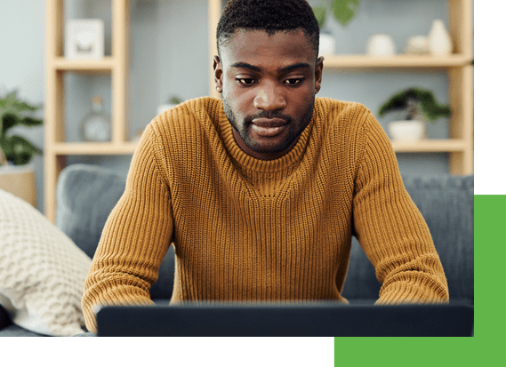 man in yellow sweater browses hvac rebates online