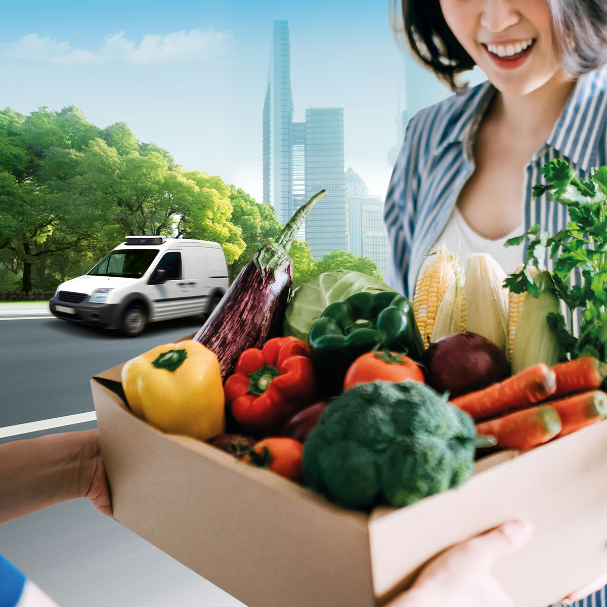Carrier Neos HE truck refrigeration unit on van driving behind woman receiving a box of fresh vegetables