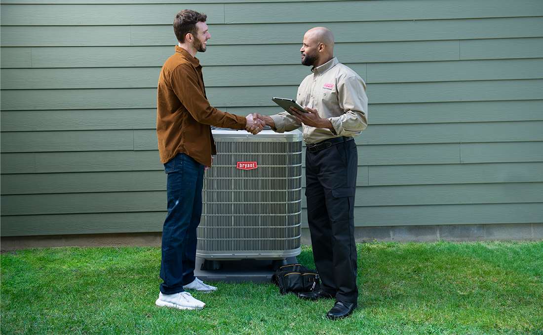 bryant-dealer-discusses-hvac-parts-needed-with-homeowner-by-ac-unit
