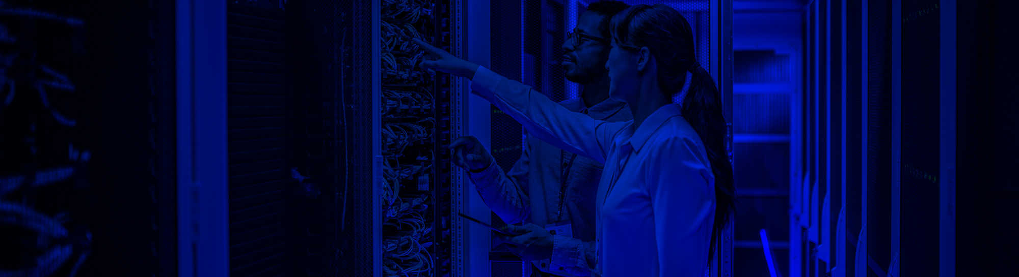 man-woman-in-data-center-2000x550