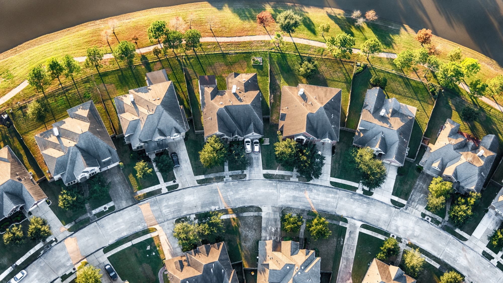 Aerial view of home rooftops in sunny suburban neighborhood