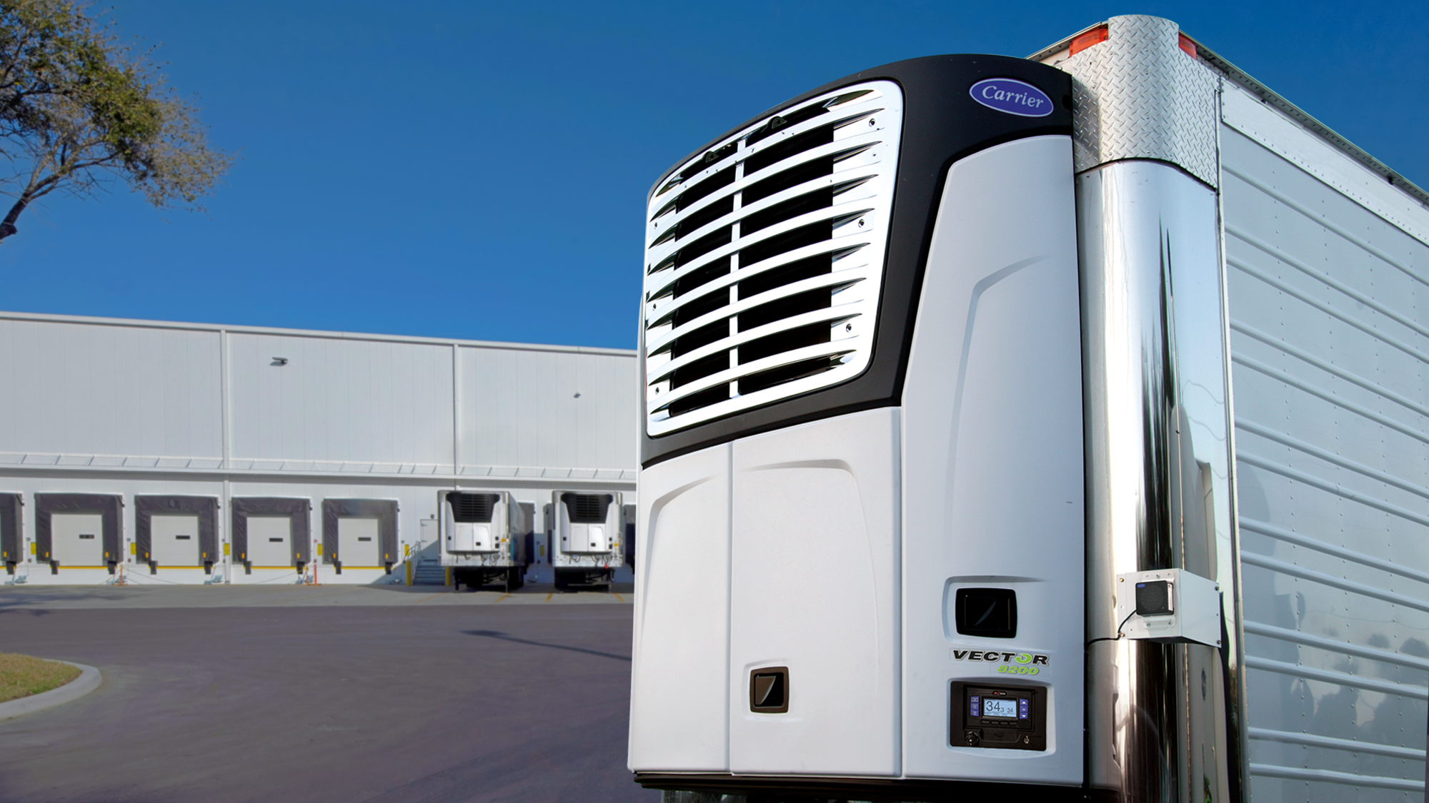 Carrier Vector 8200 Trailer Refrigeration Unit on trailer in front of distribution center
