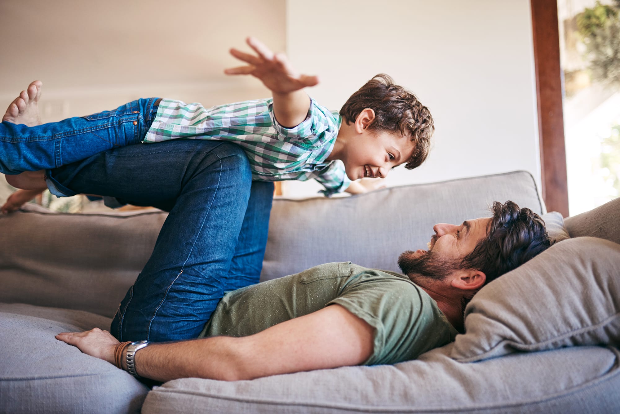 father-and-son-on-couch-playful
