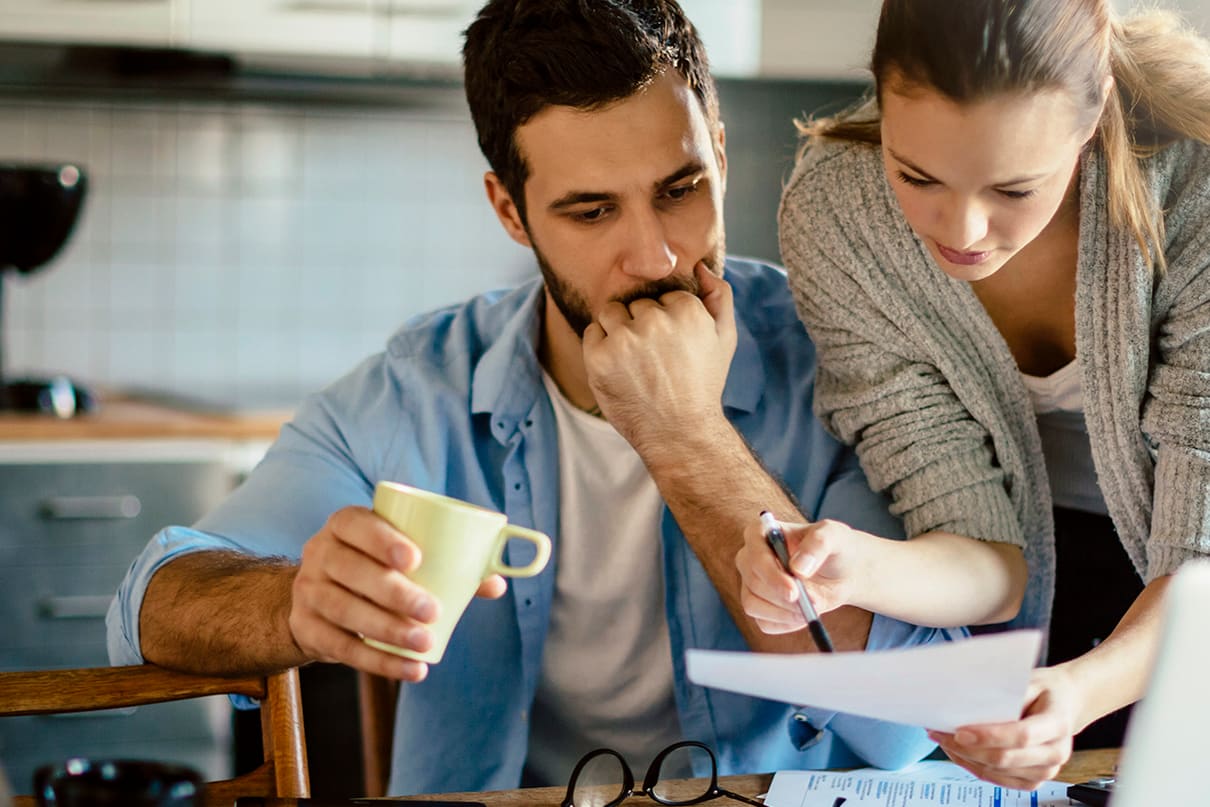 couple-at-kitchen-table-with-coffee-reviewing-finances-3x2