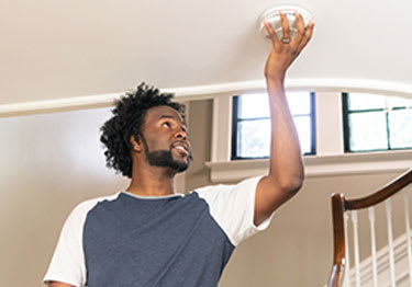 home-safety-man-installing-alarm