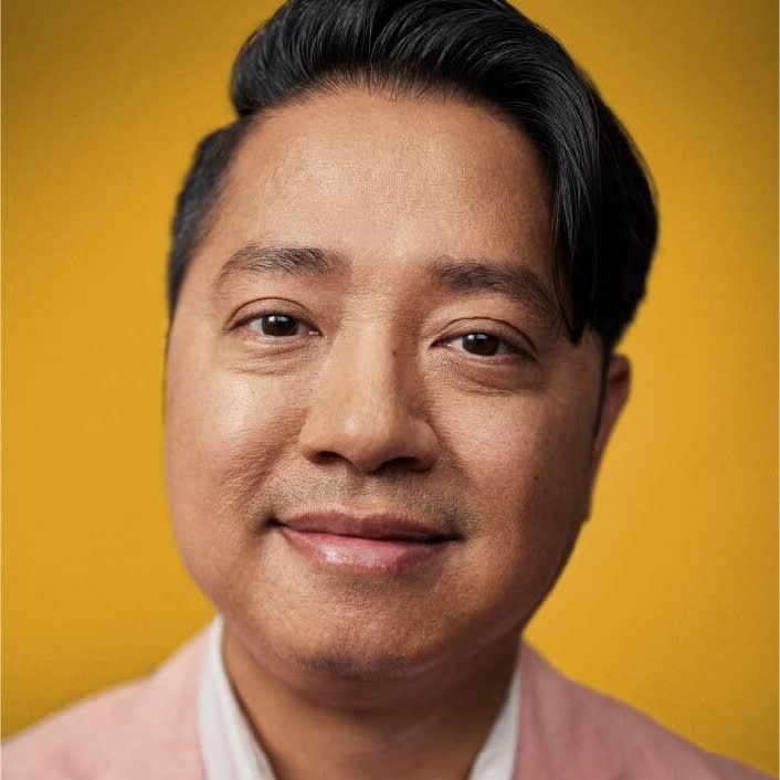 Close up portrait of smiling Asian-America real estate agent Man Hyunh