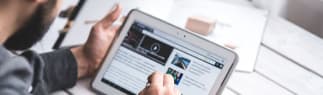 person-reading-news-on-tab-1x4