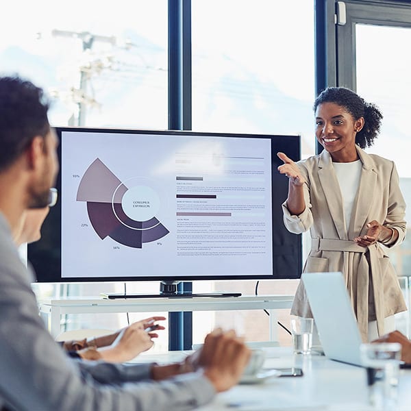 speaker-speaking-with-coworkers-in-conference-room-sq