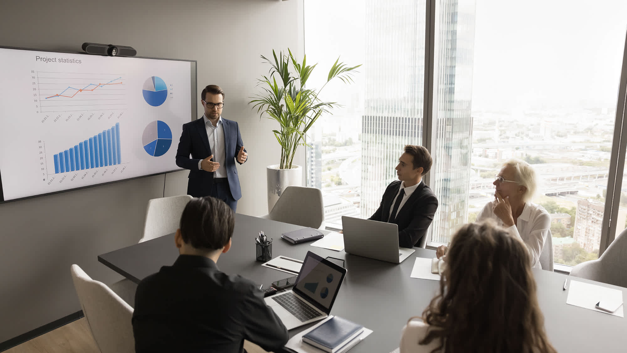 man-talking-to-group-in-conference-room-16x9