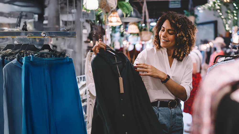 woman-in-retail-store-looking-at-clothes-16x9