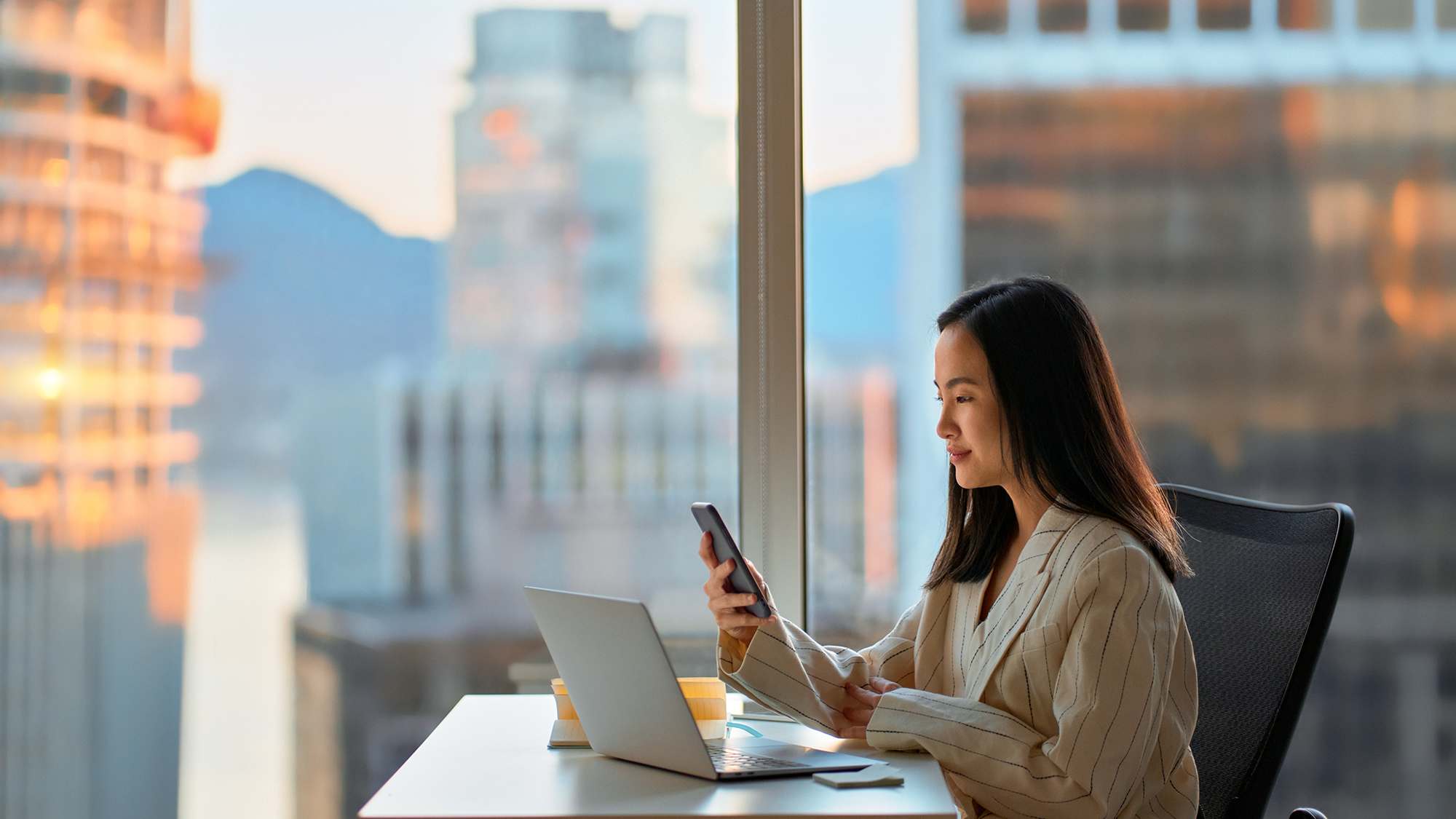 woman-with-cell-phone-in-front-of-building-16x9