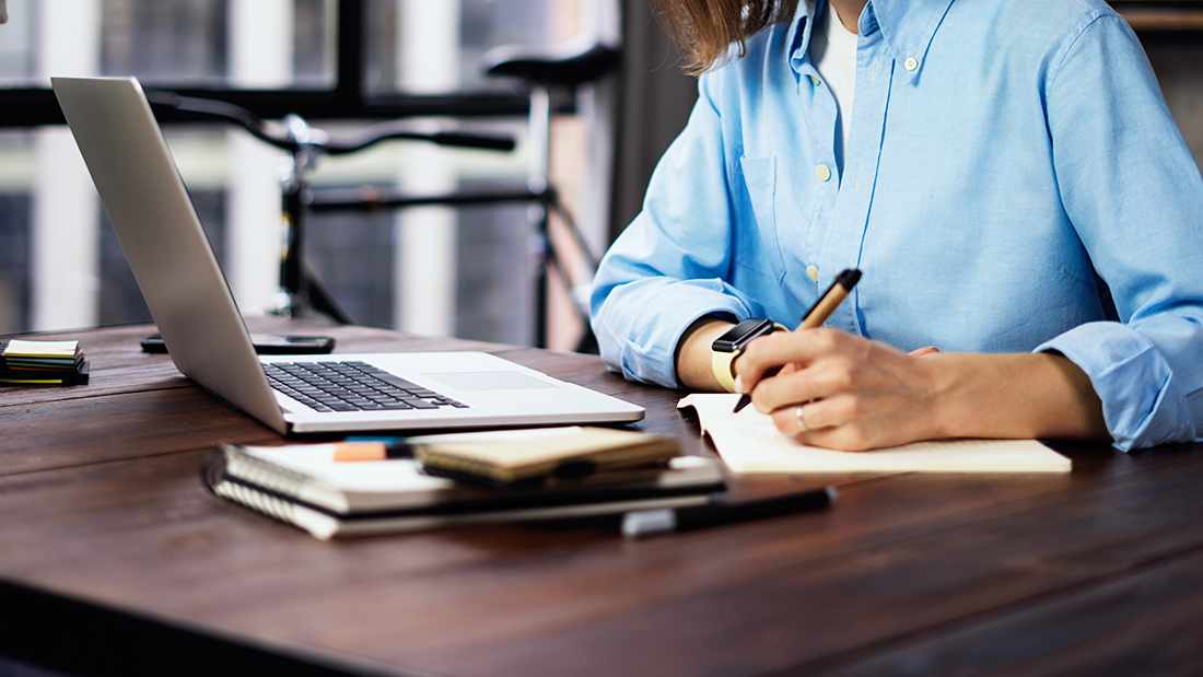 woman-writing-at-desk-16x9