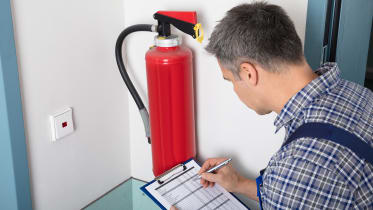 technician-checking-fire-extinguisher_01_16x9