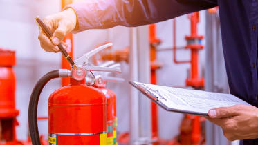 technician-clipboard-checking-fire-extinguisher-pressure_01_16x9