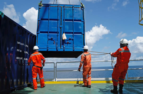 container-ship-workers-moving-container