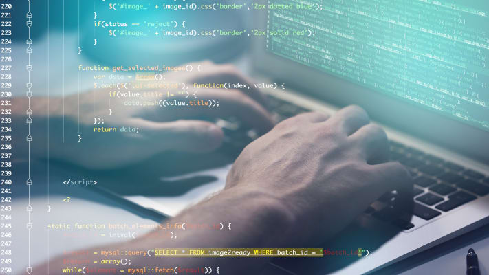 carrier-computer-programmer-at-keyboard-with-computer-code