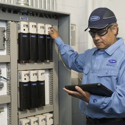 carrier-service-technician-in-equipment-room-servicing-panel-mobile