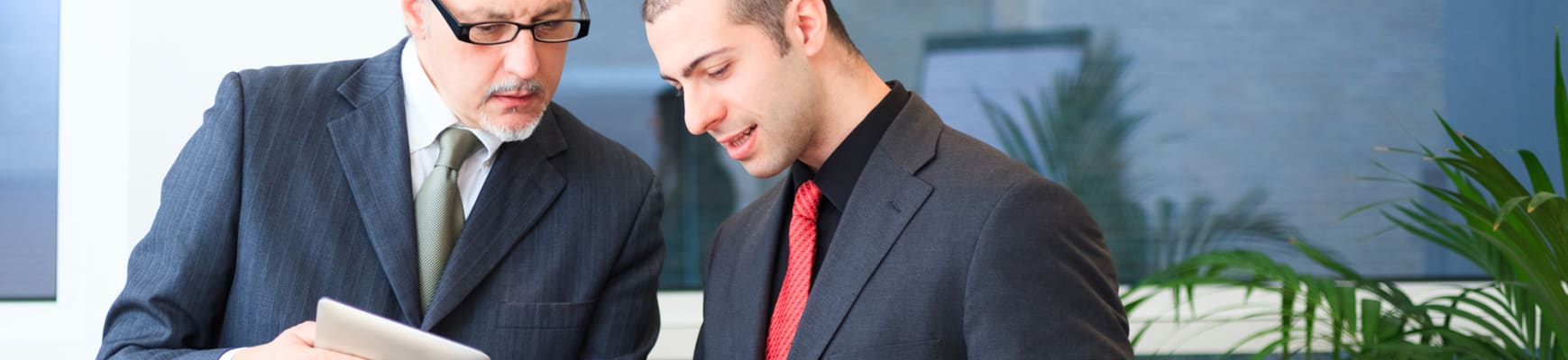 carrier-older-and-younger-professional-men-reviewing-documents-sm