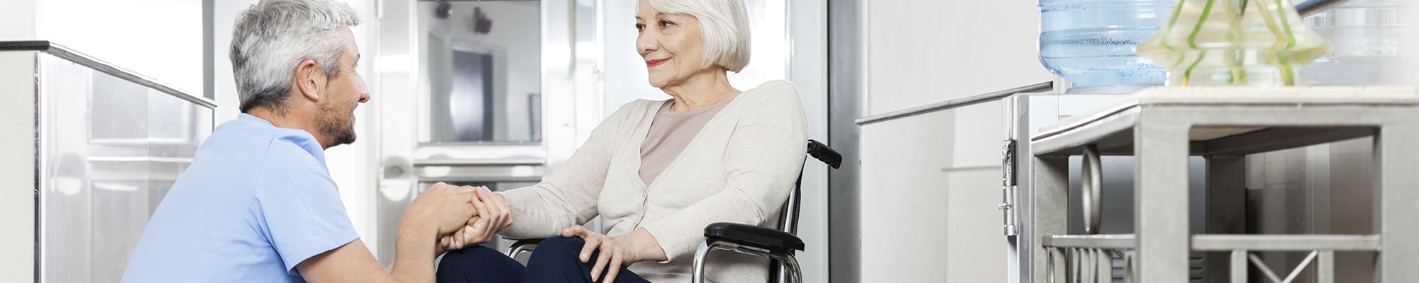 carrier-healthcare-worker-with-older-woman-in-wheelchair