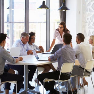 businesswoman-presenting-to-team_1x1