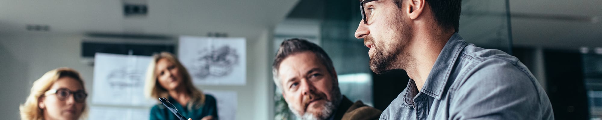 Engineers in meeting room discussing a project