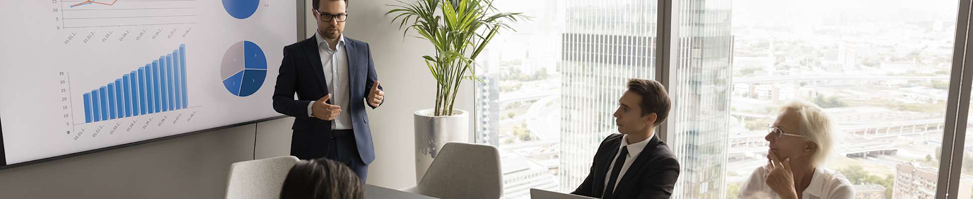 man-talking-to-group-in-conference-room-2000x400