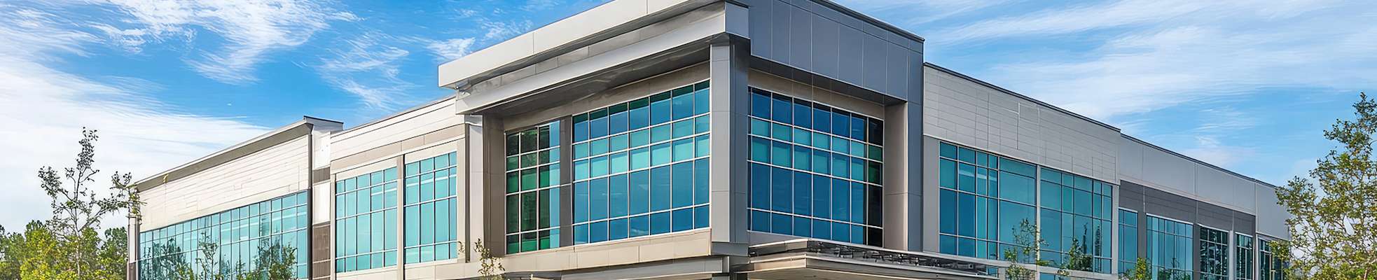 modern-office-building-with-clear-blue-sky-2000x400